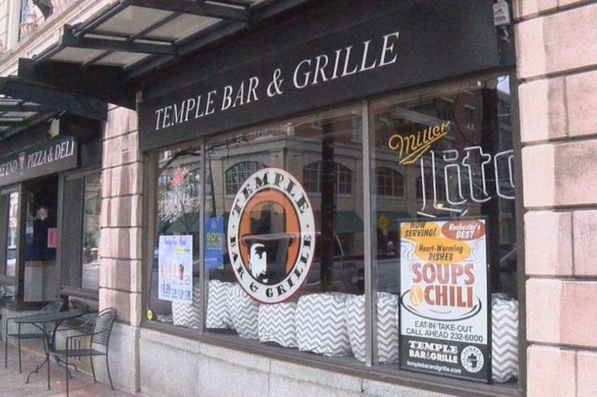 A restaurant named Temple Bar & Grille with a signboard advertising soups and chili. 3