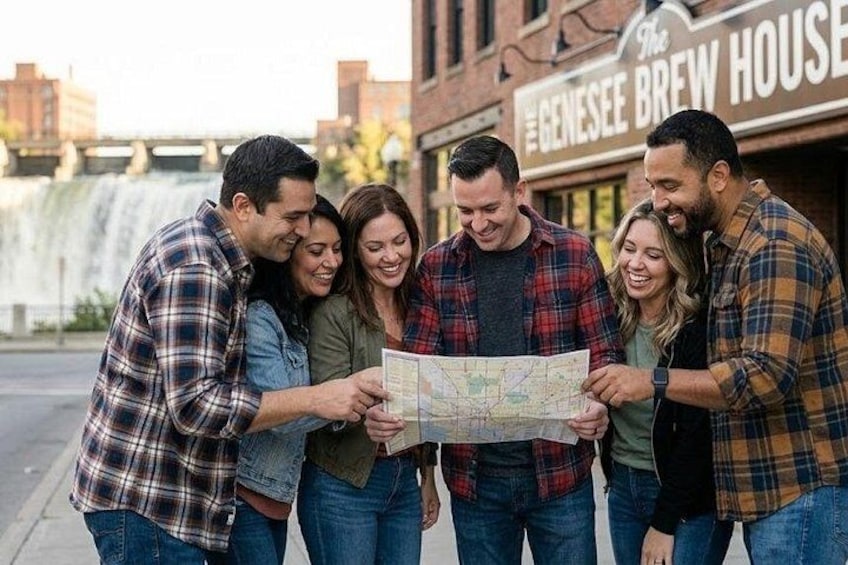 A group of people looking at a map in front of a building with a sign that reads 'The Genesee Brew House.' 1