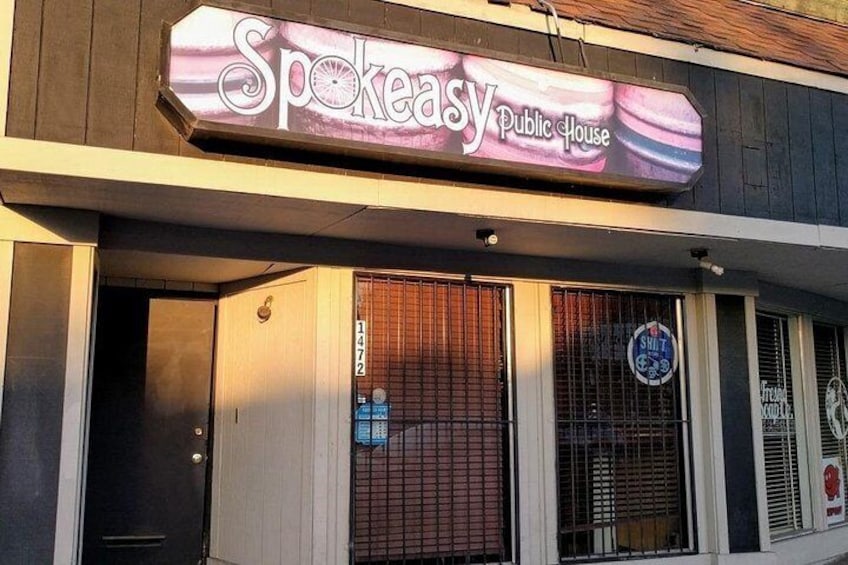 A building with a sign that reads 'Spokeasy Public House.' 4