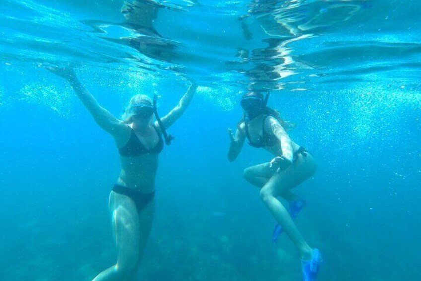 Two people snorkeling underwater. 5