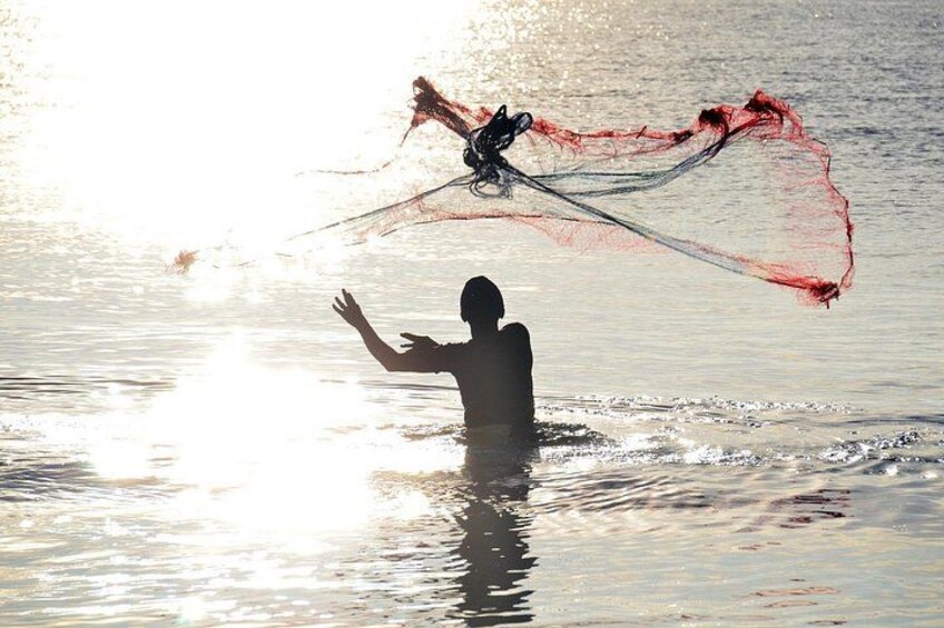 A person in water with a red and black kite. 4
