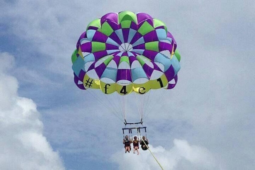 Een parachute met een patroon in paars, groen en blauw, en het nummer 4141. 4