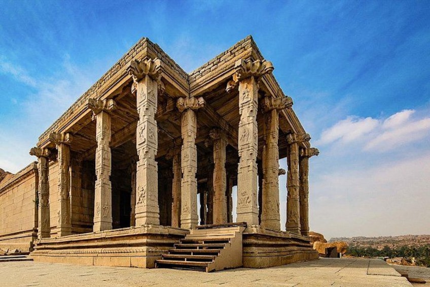 A large, ancient stone structure with multiple columns and a stepped entrance. 2