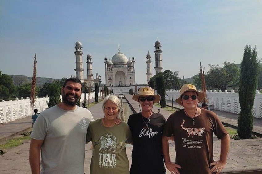 Four people standing in front of the Taj Mahal. 1