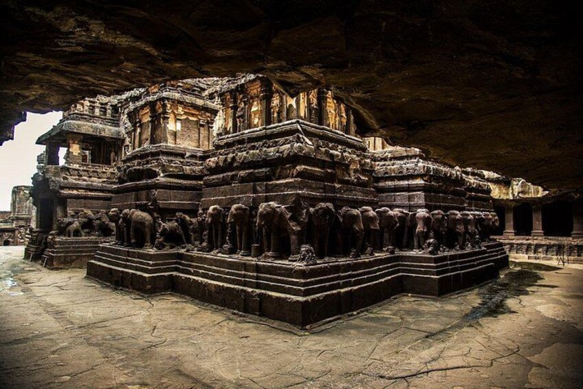 An ancient temple with intricate carvings and a large group of statues. 3