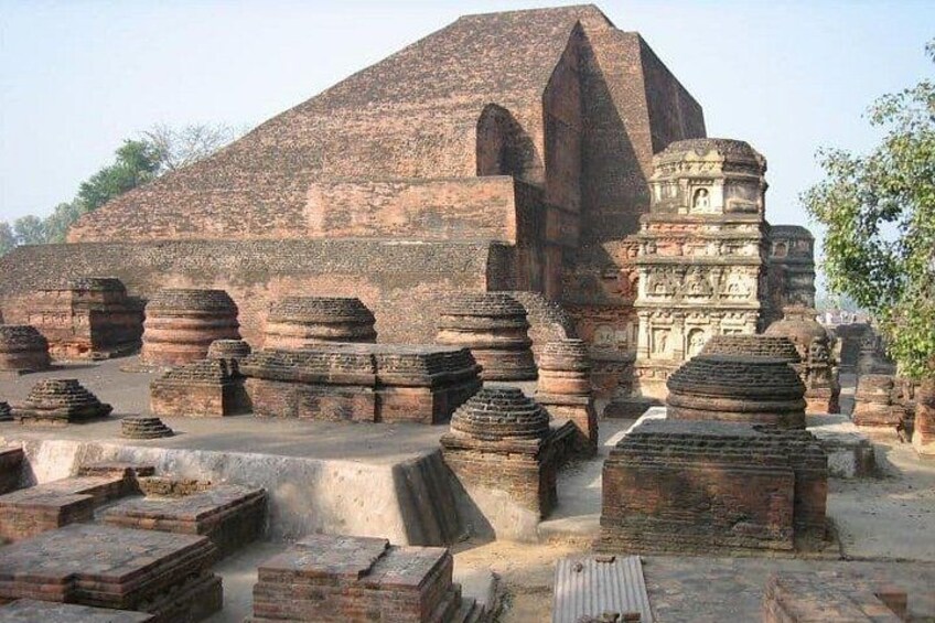 Ancient brick structures, including a large pyramid-like building and smaller stupa-like monuments. 5