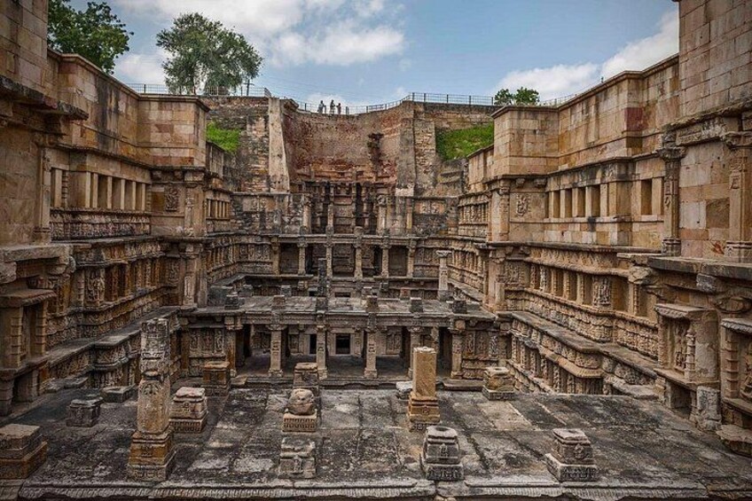 An ancient stone structure with intricate carvings and a central courtyard. 2