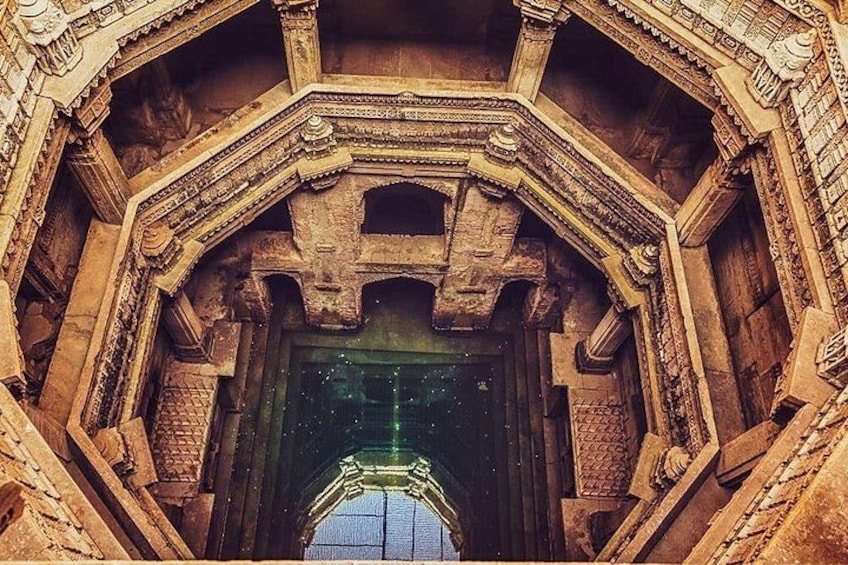 An ornate stone structure with intricate carvings and a large, arched doorway. 1