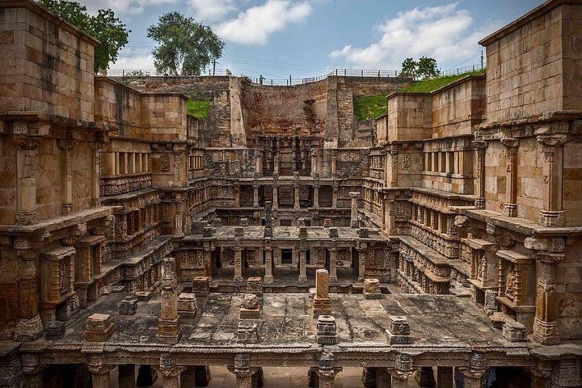 An ancient stone structure with intricate carvings and multiple levels. 4