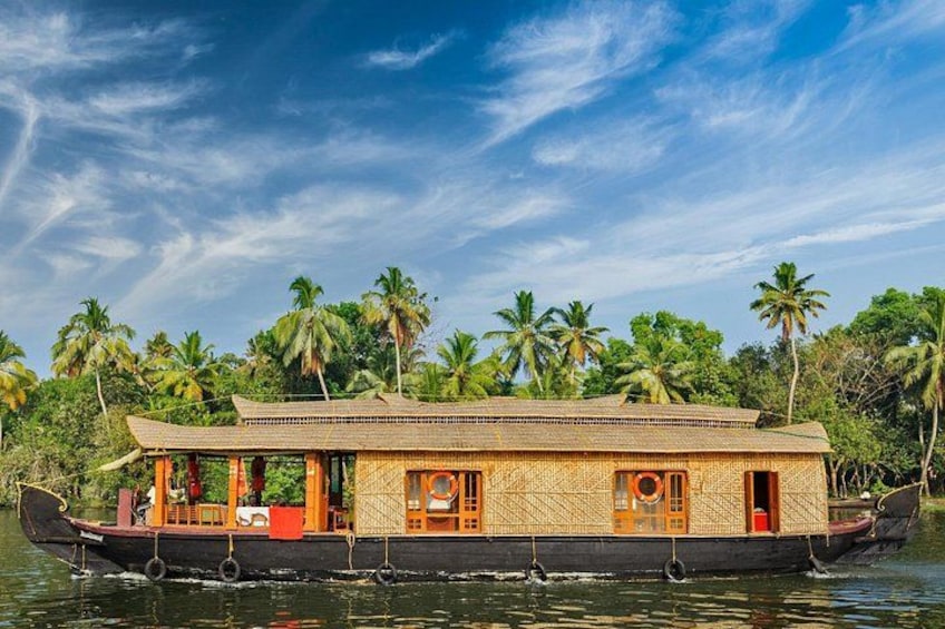 A houseboat on water surrounded by palm trees. 2