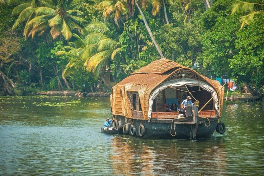 A houseboat on water surrounded by palm trees. 2