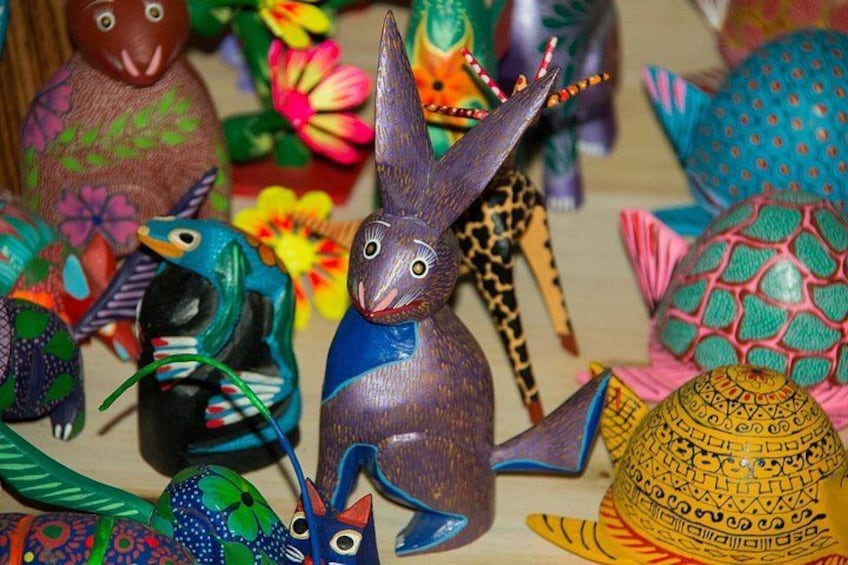 A collection of colorful, intricately carved wooden figures. 4