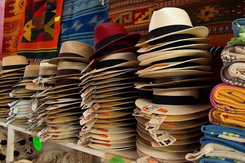 A variety of hats stacked on shelves. 3