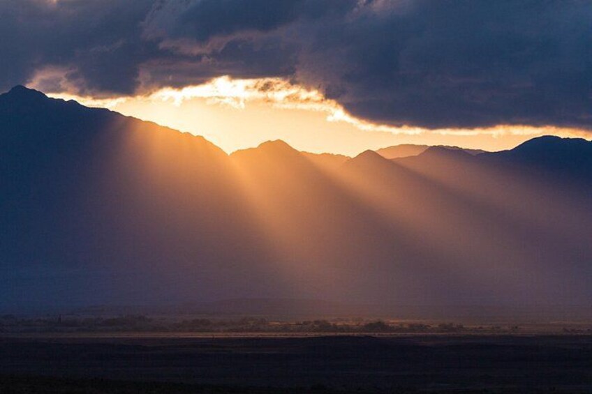 A mountain range with sunlight filtering through clouds. 2