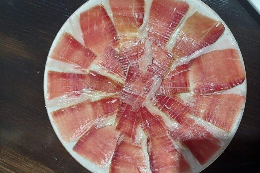 A circular arrangement of sliced meat with a central core. 4