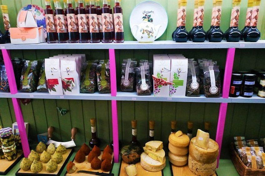 Shelves stocked with various food items, including jars, bottles, and packaged goods. 3