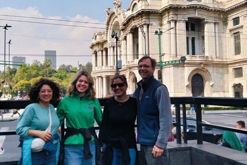 Un gruppo di persone in piedi di fronte a un edificio storico con architettura elaborata. 3