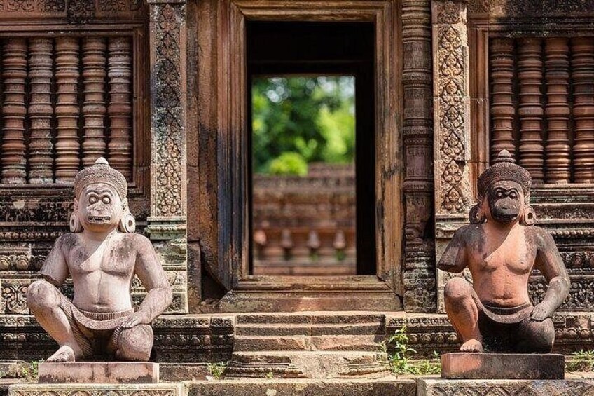 A temple entrance with stone statues and intricate carvings. 2