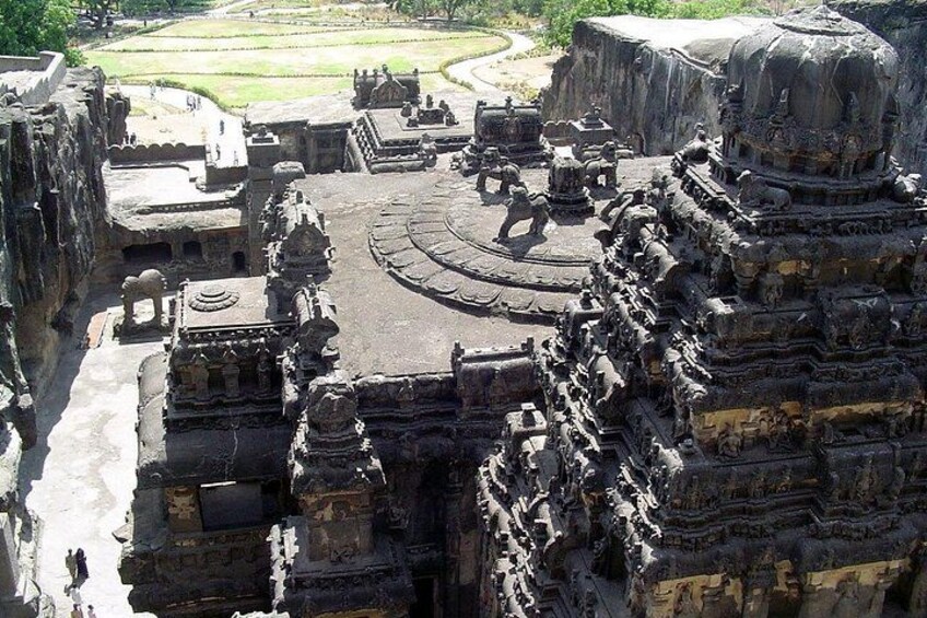 An ancient temple complex with intricate carvings and a large central structure. 2