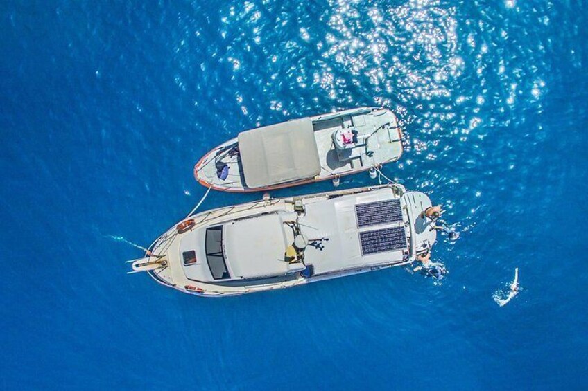 Two boats tied together in the water. 3