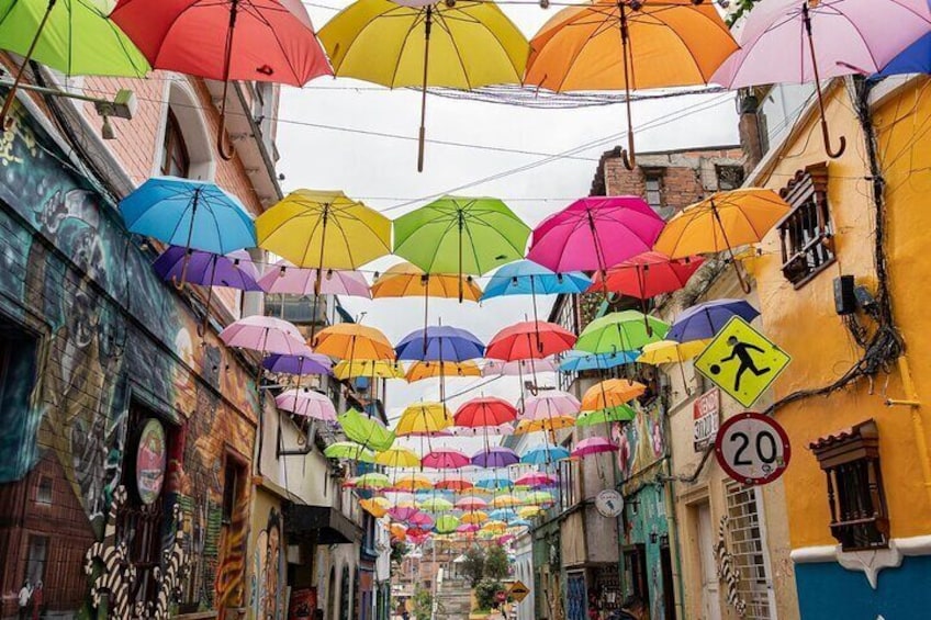 A street with colorful umbrellas hanging overhead. 3