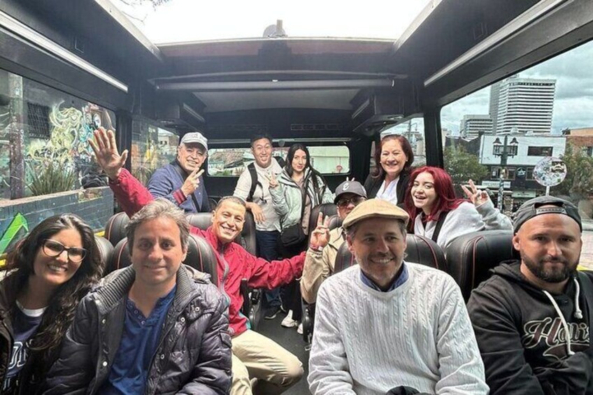A group of people inside a vehicle with graffiti on the windows. 5
