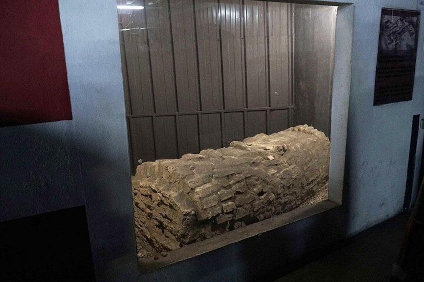 A stone sarcophagus in a display case. 3