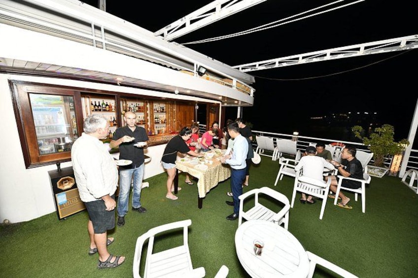 An outdoor bar area with people dining and socializing. 4
