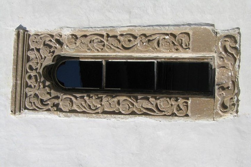 A decorative window with intricate carvings. 1