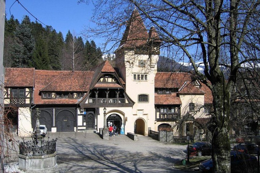 A traditional building with a steep roof, large windows, and a central tower. 2