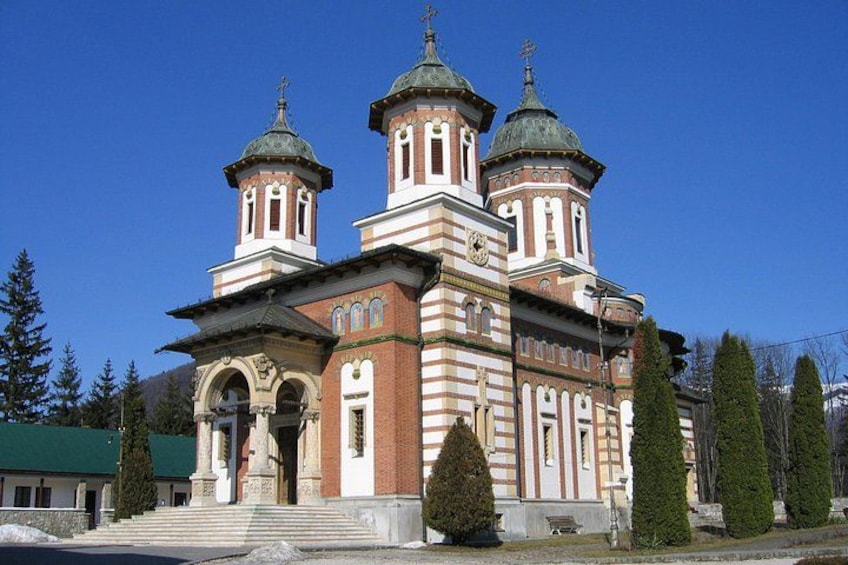 A large, historic church with three domes and a bell tower. 5