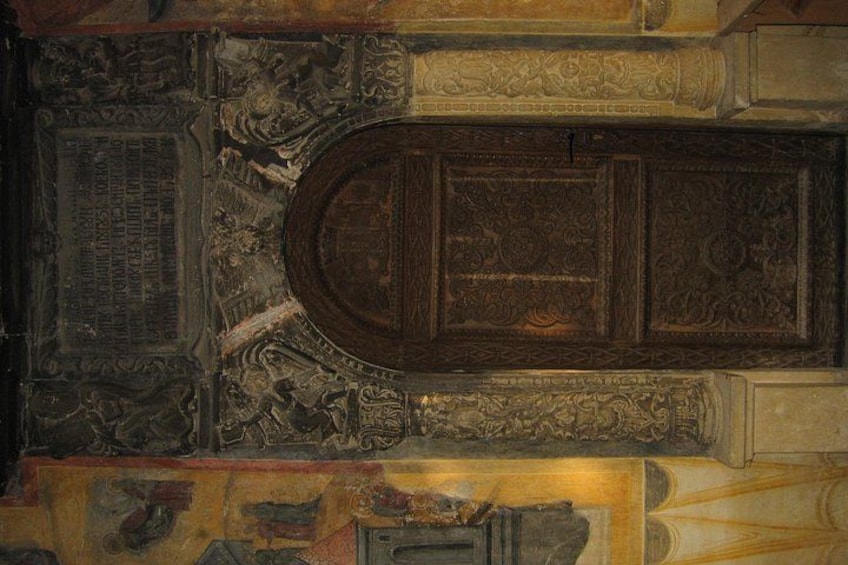 An ornate ceiling with intricate carvings and a central medallion. 4