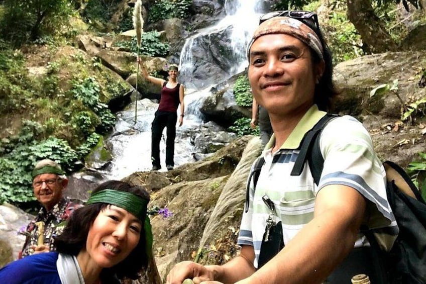 A waterfall, hikers, and a rocky terrain. 4