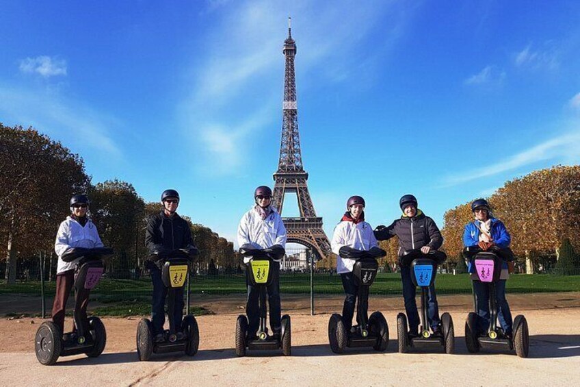 En gruppe mennesker på segways foran Eiffeltårnet. 2