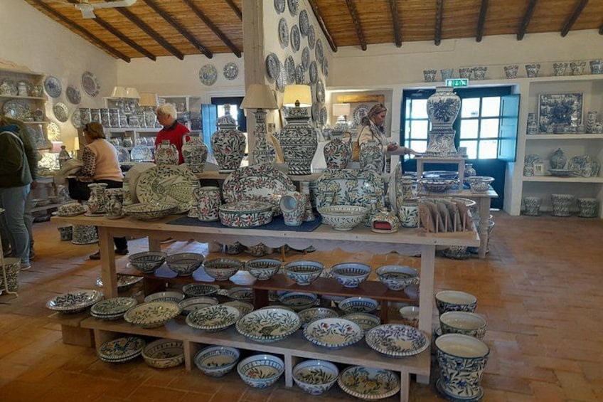 A pottery workshop with shelves of ceramic bowls and plates. 5