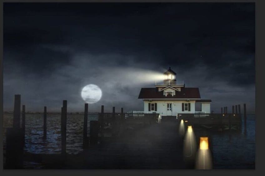 A lighthouse on a pier at night with a full moon in the background. 5