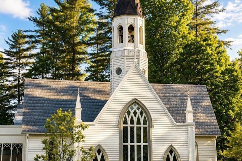 A church with a steeple, arched windows, and a pointed roof. 4