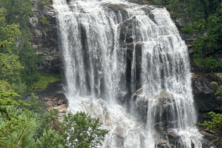 A multi-tiered waterfall surrounded by lush greenery. 5