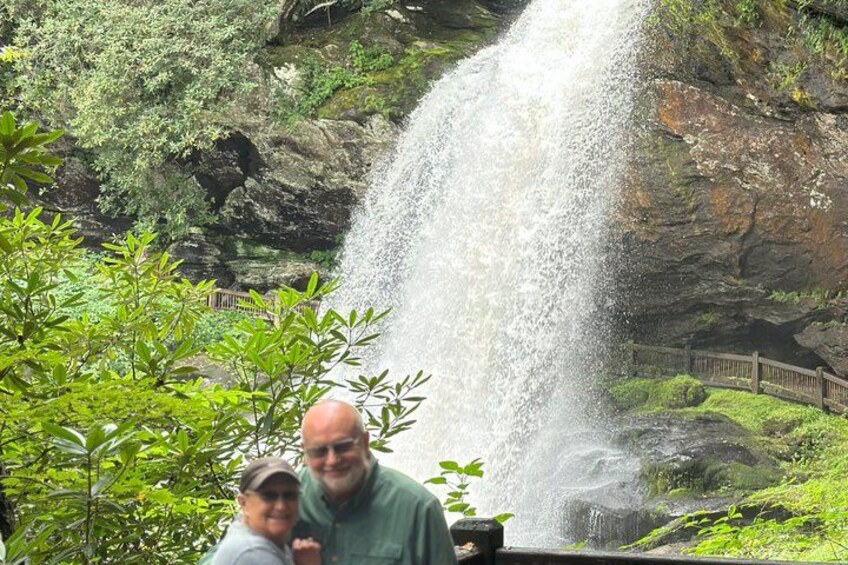 A waterfall cascading down a rocky cliff surrounded by greenery. 4