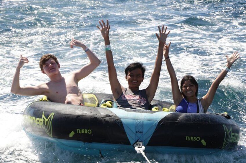 A group of people on a watercraft with 'TURBO' written on it. 3