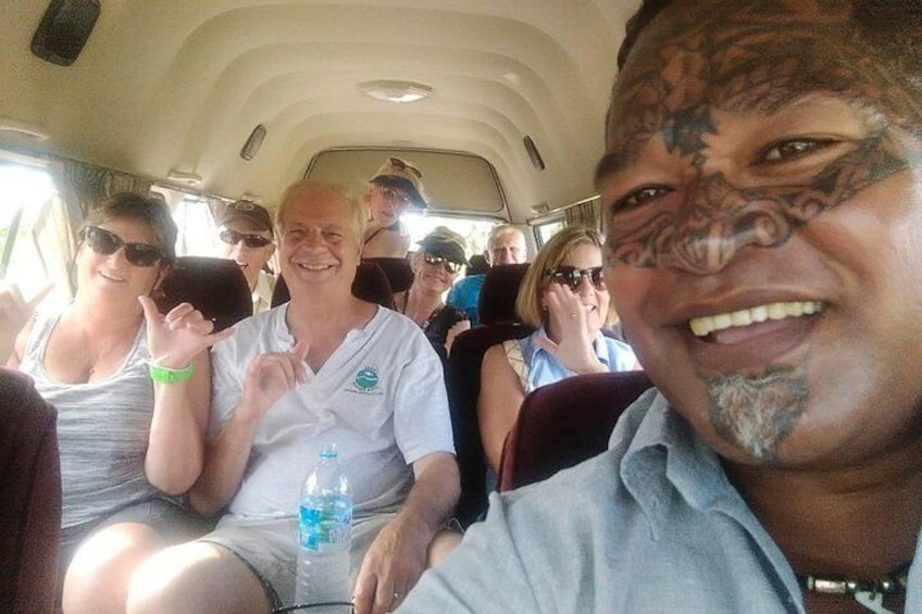 A group of people seated inside a vehicle, possibly a bus or van. 4