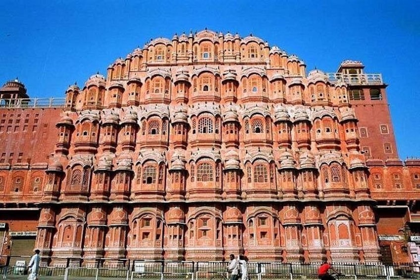 A large, ornate building with intricate architectural details and multiple levels of balconies. 4