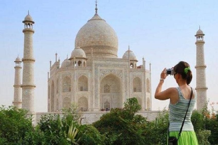 A person taking a photo of the Taj Mahal. 2