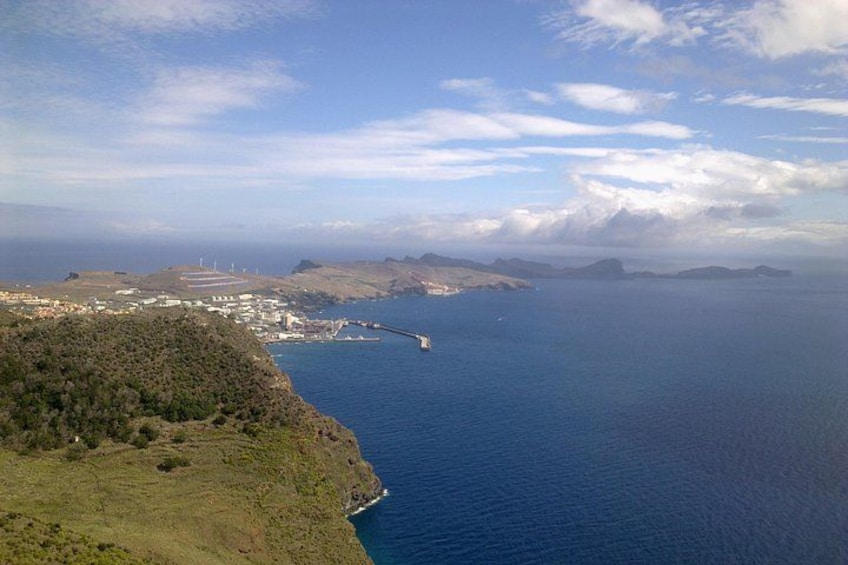 A coastal landscape with a bridge, hills, and a distant shoreline. 2