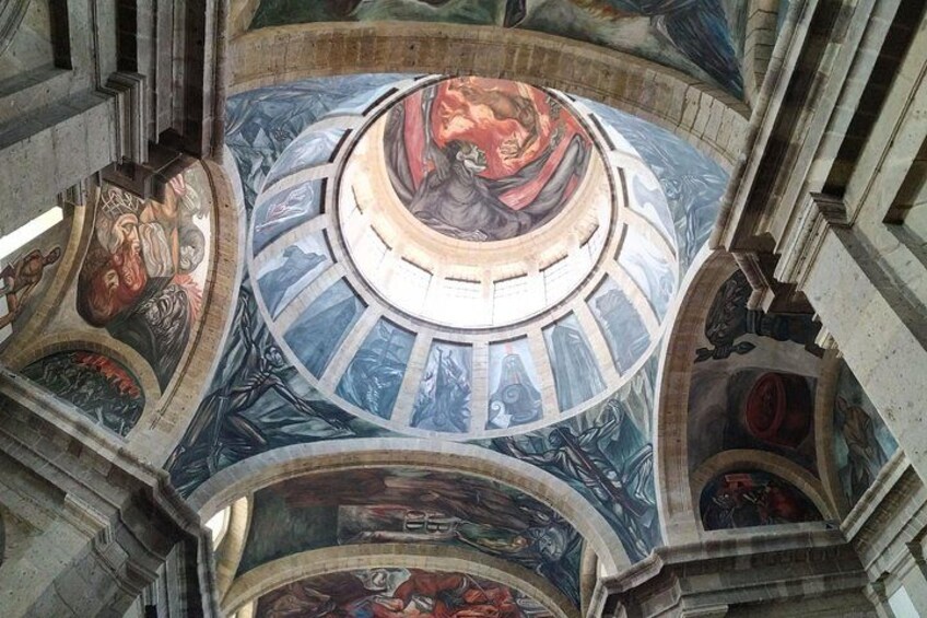 A domed ceiling with intricate frescoes and architectural details. 5