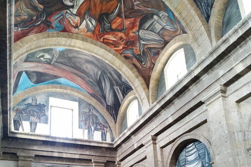 A detailed ceiling fresco with architectural arches and a window. 4