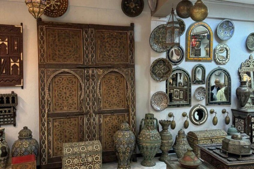 A variety of ornate metalwork and decorative items, including mirrors, vases, and patterned boxes. 5