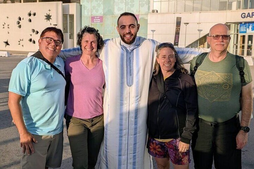 A group of people standing together in front of a building with a sign that reads "GAR". 3