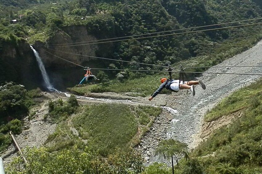 A person bungee jumping off a bridge with a waterfall in the background. 5