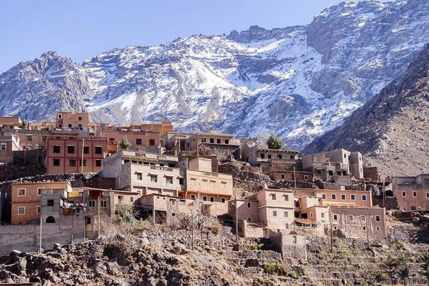 A mountainous village with buildings nestled against a snow-capped backdrop. 2